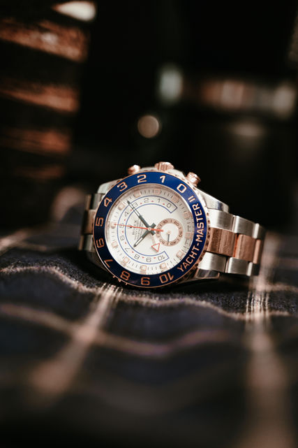 Close-up of a silver and blue chronograph watch placed on fabric.