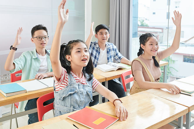 student at tuition centre raising hands asking question