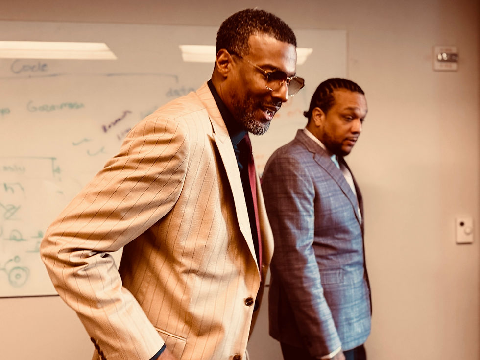 Eugene Reid and Gary Fortson, co-founders of G2MDA, standing in their Apple Developer Academy office space, looking focused and prepared before presenting to the President of Michigan State University.