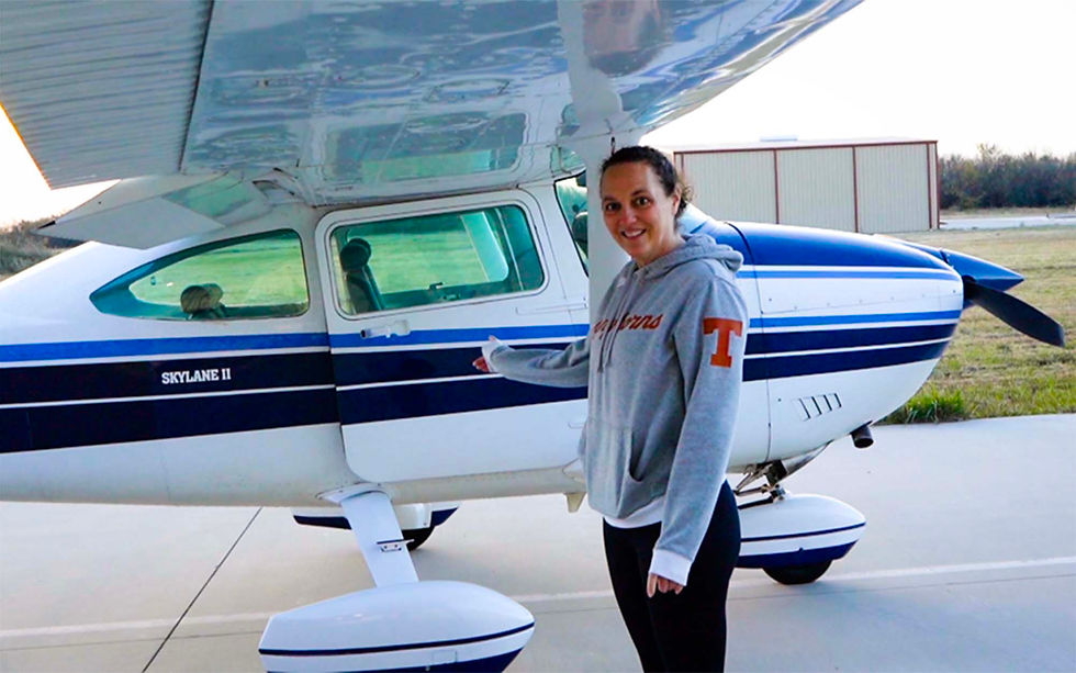 Cori points to her plane and asks passengers if they're ready to board for flight. Cori earned her private pilot's license with CFI Kade Hermes of Ayers Aviation at Gainesville Municipal Airport and has taken a few lessons toward earning an instrument rating.