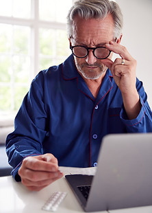 mature-man-at-home-looking-up-informatio