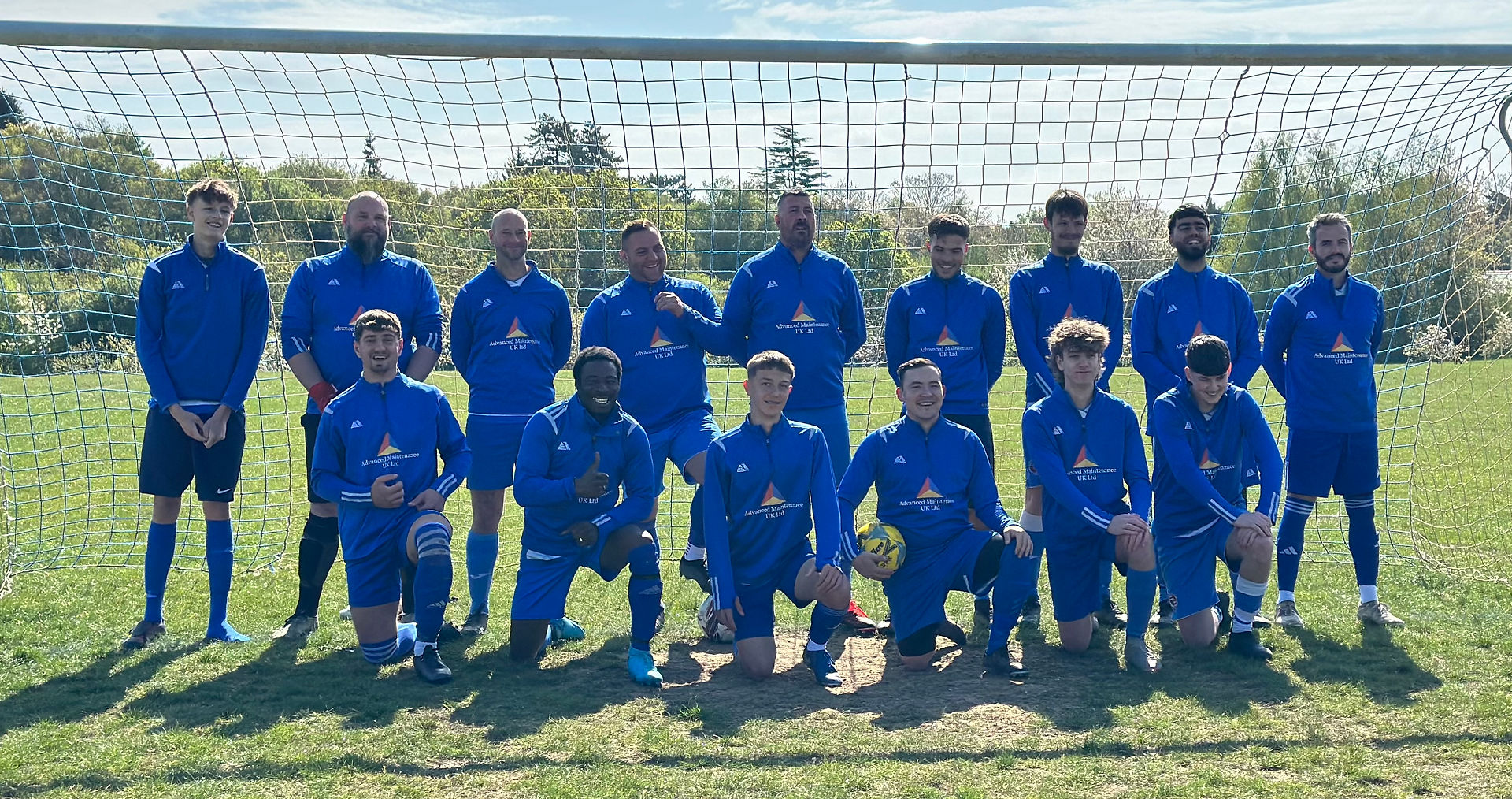 Advanced Maintenance UK Ltd sponsered football team group photo in blue kits, standing in front of a goal.