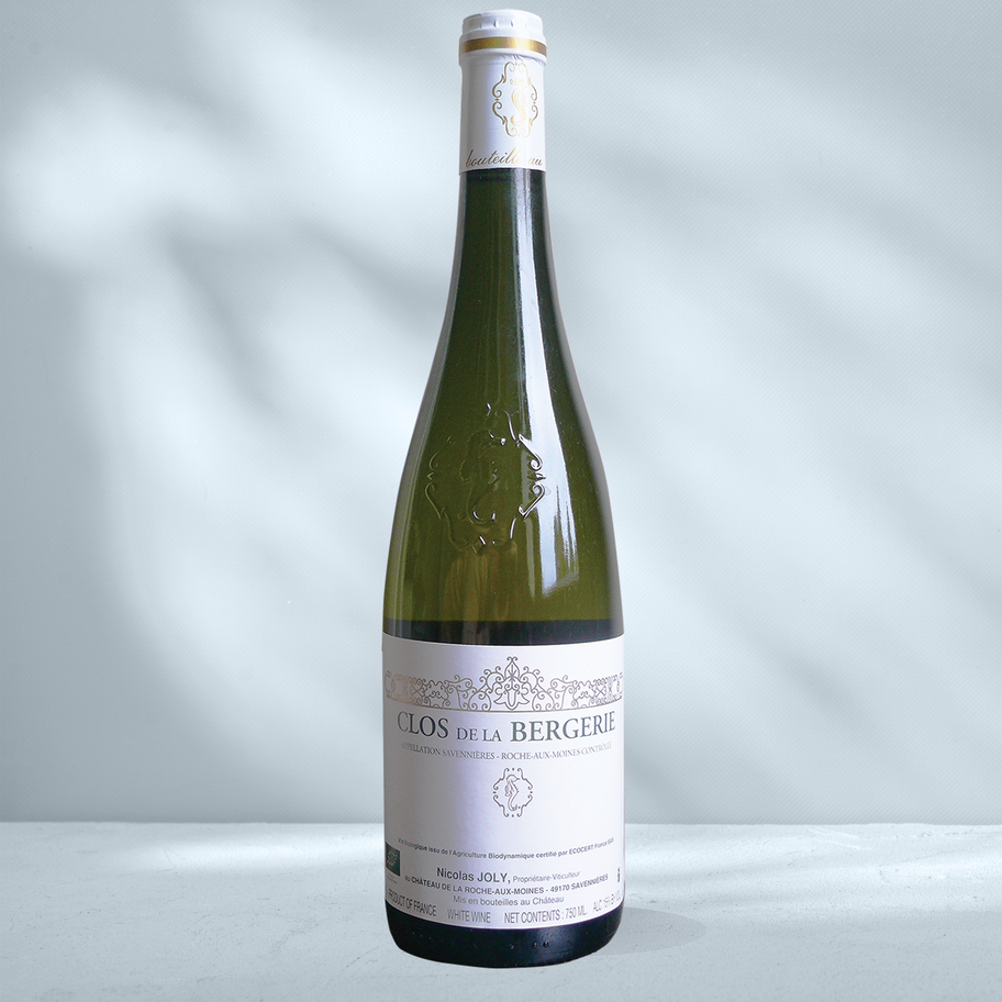 Bottle of Famille Joly Clos de la Bergerie with white label showing Joly branding and Roche Aux Moines designation