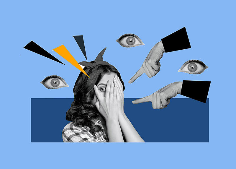 Woman in distress with hands over face and one eye peeking out surrounded by eyeballs fingers pointing at her in accusation.