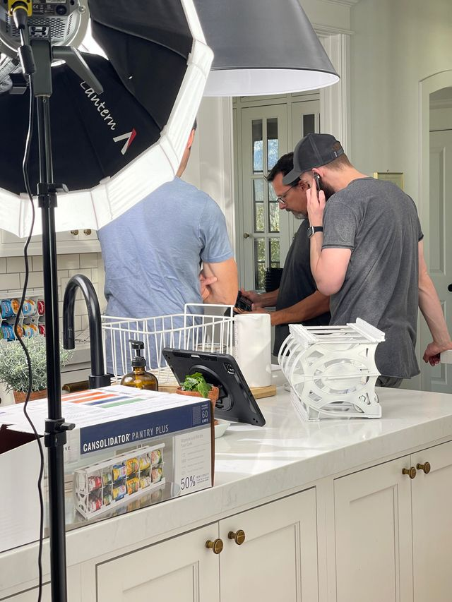 Production crew filming a product scene with professional lighting for a commercial video shoot