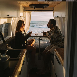 Couple enjoying the view from the Keen Camper van