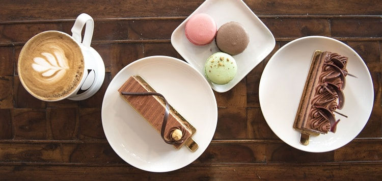 Spread of Delice pastries, cakes, and coffee