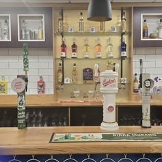 Bar counter with beer taps and liquor bottles.