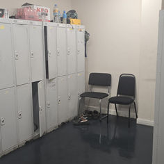 Commercial cleaning of a locker room with metal lockers.