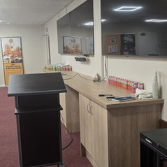 Clean commercial office training room with podium and screens