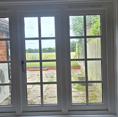 Clean white multi-pane window with view of a green field
