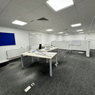 Modern office space with desks and LED lighting