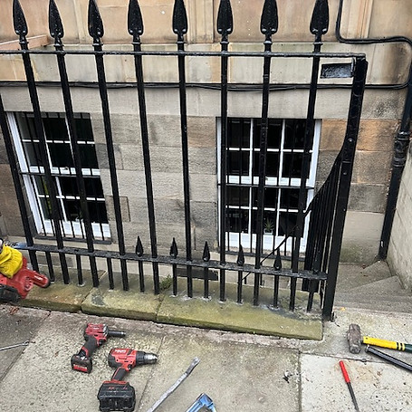 Damaged wrought iron fence repair in progress