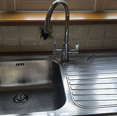 Clean stainless steel kitchen sink and faucet