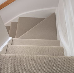Clean beige carpeted stairs in a commercial building