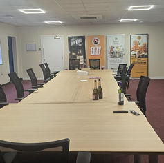 Clean, modern boardroom with conference table and chairs.