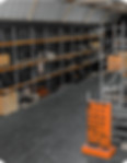 Warehouse with stacked pallets of finished industrial equipment.