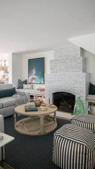 A whitewashed fireplace with bench seating on each side