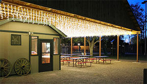 Covered cookout pavilion lit with hanging lights at USA RV Park in Gallup, New Mexico
