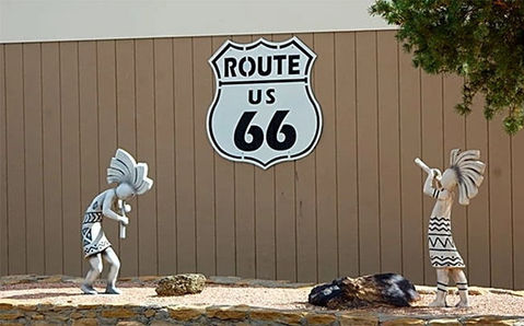 Native-inspired sculptures and a large Route 66 sign at USA RV Park in Gallup, New Mexico