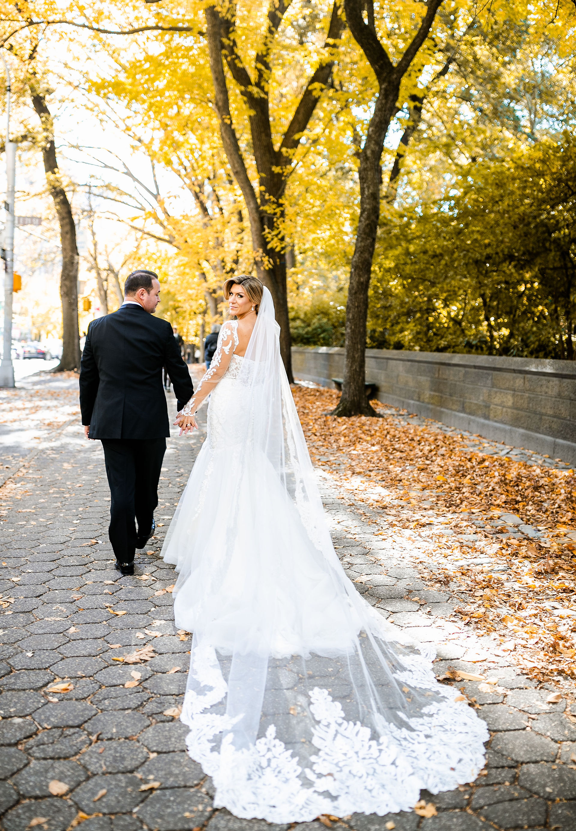 Bride and Groom walking in Central Park.