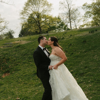 bride and groom kiss outdoors before their wedding ceremony