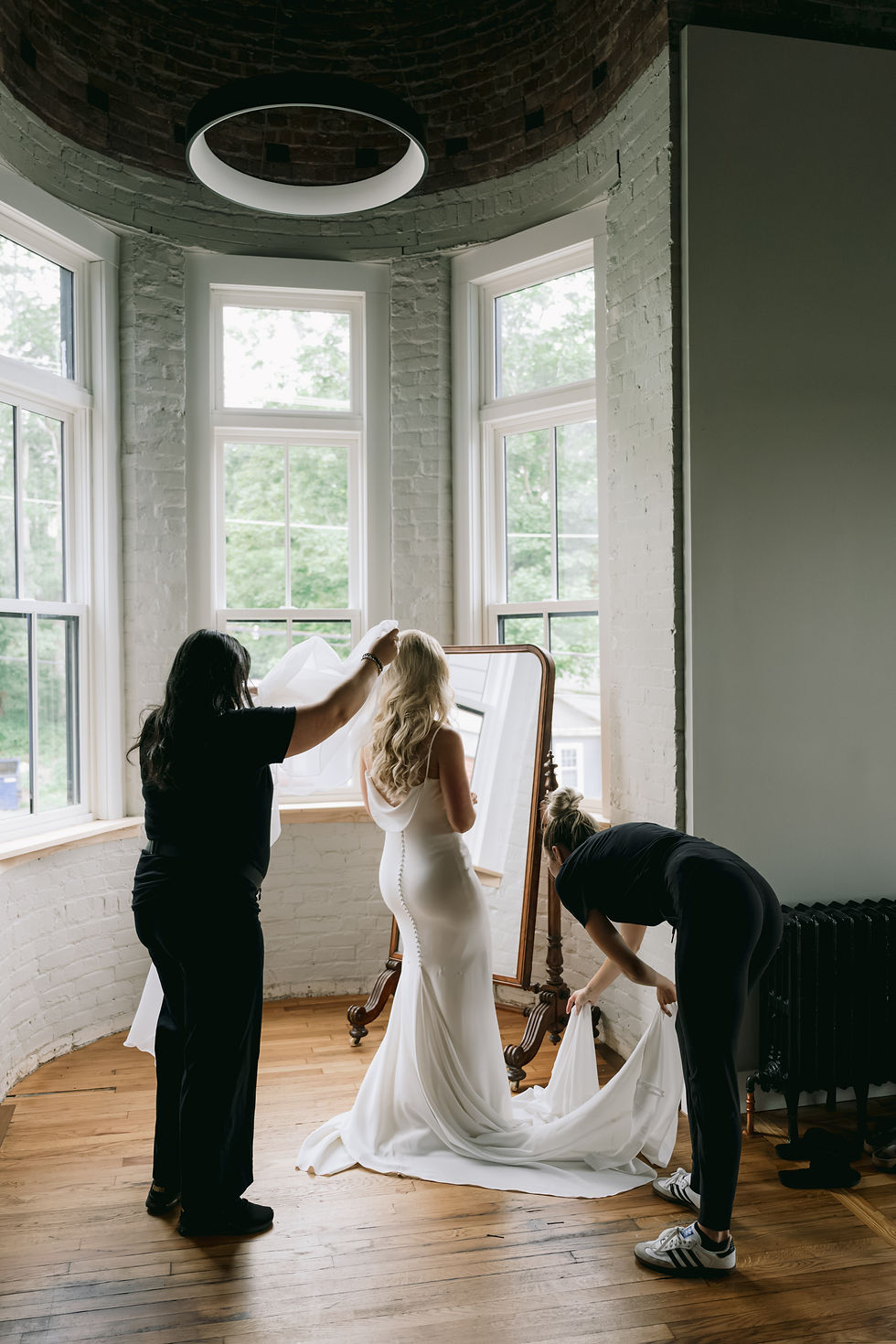 wedding planner helping bride with her veil
