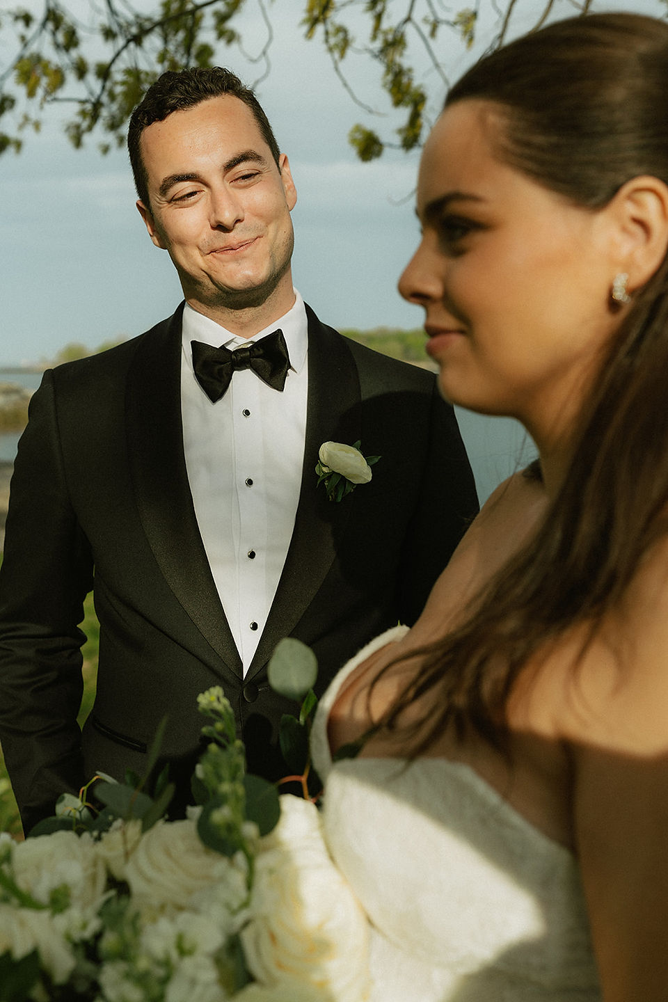 groom looks lovingly at his bride during photos 
