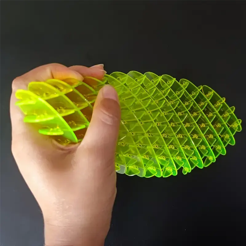 hand  holding the yellow fidget contort
