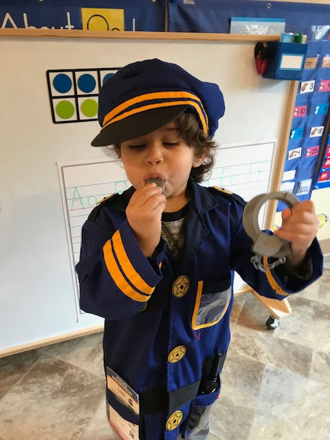 Young child dressed up like a navy captain.