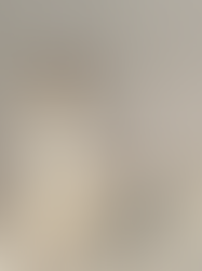 A woman wearing butter yellow voluminous balloon pants with a peplum hem and strappy high heels, demonstrating a key Summer 2026 fashion trend for structured, monochromatic silhouettes.