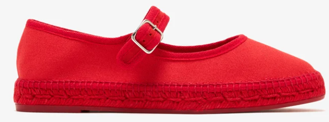 Red flat shoe with a buckle strap on a white background, shown in side view.