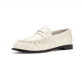 Cream-colored loafer shoe isolated on a white background, shown in side view with a black sole.