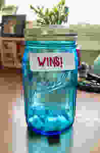mason jar with sticker that says "wins"