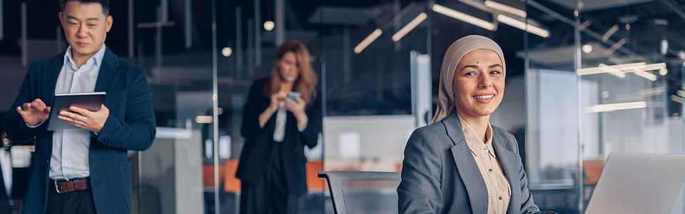 smiling-muslim-businesswoman-in-hijab-working-on-c-2025-03-15-03-01-31-utc.jpg
