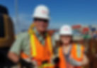 Two people wearing hard hats at a jobsite.