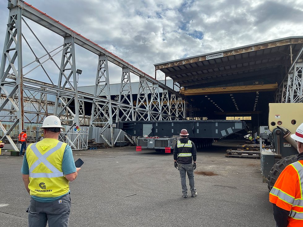 Greenberry personnel look on as the gate leaves are loaded onto a self-propelled modular transporter, which was then loaded onto the MANSON 73 barge. Photo credit: Kurtis Jackson—Project Engineer