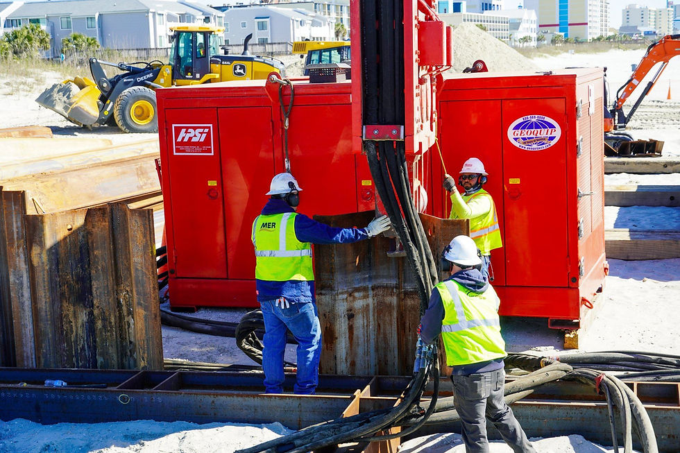 Three piledrivers on a jobsite.