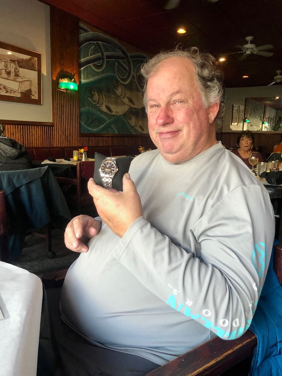 Crew Boat Captain Jeff Burks holds his Manson watch in recognition of 25 years with the organization.