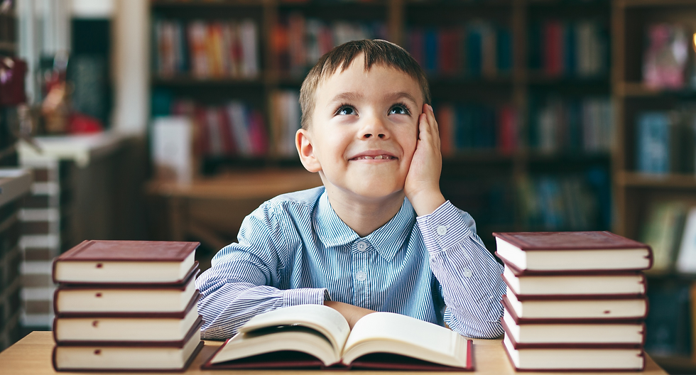 Single%20dreaming%20boy%20at%20the%20desk%20in%20the%20library%20enjoy%20books.%20Front%20