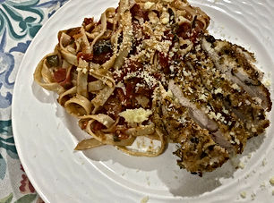 Pasta alla puttanesca with breadcrumbed herbed chicken