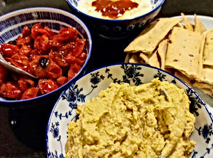 Roasted carrot hummus, roast tomatoes, and harissa yogurt