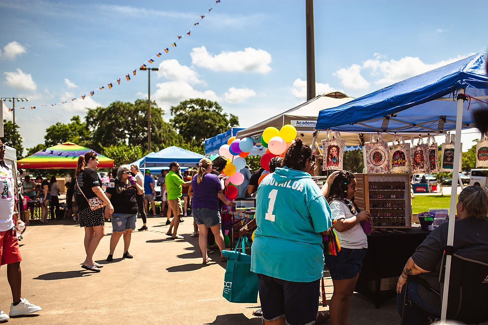 Community members gather around colorful Pride booths at the BCP picnic in Lake Jackson, Texas, celebrating diversity and unity.