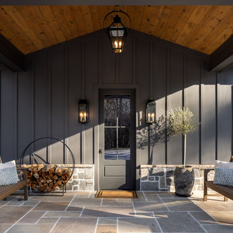 Exterior view of black hardie plank hunting lodge with wood ceilings