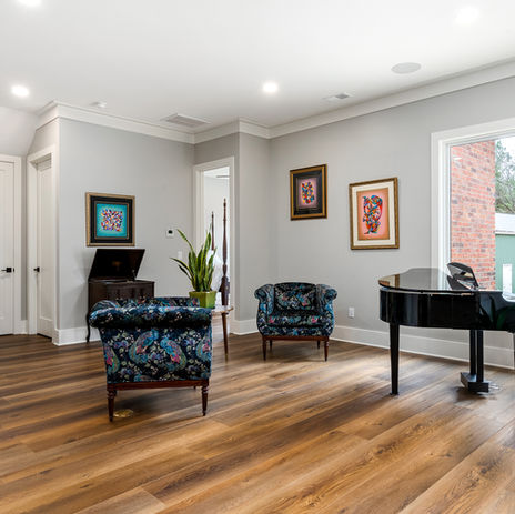 Modern living room with hardwood floors in Custom built brick home with luxurious large kitchen, tile bathroom, and outdoor pool. Columbia, SC