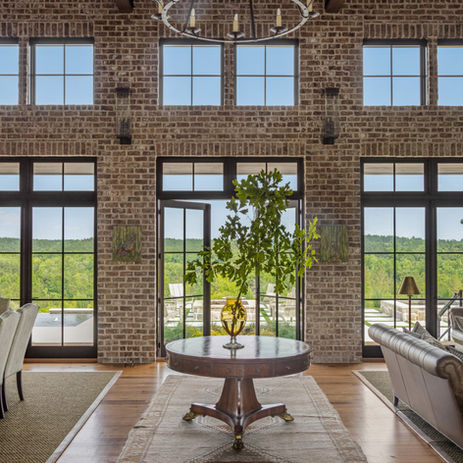 Brick foyer in custom luxury mansion with entry table