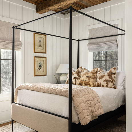 Hunting lodge located in Blackstock, SC, luxury hunting cabin. Bedroom with white walls and wood ceiling