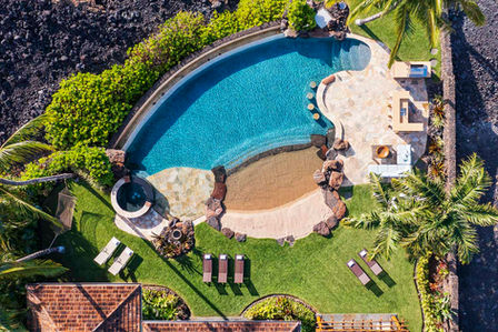 Overhead view of infinity pool at Hualalai vacation rental home with ocean view