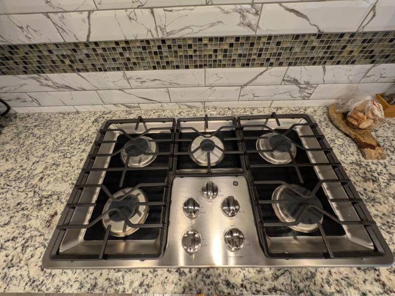 Bright modern kitchen with clean countertops and appliances after a thorough fall cleaning.