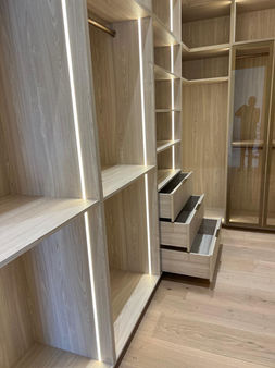 Closet cabinetry with pull-out drawers and LED strips